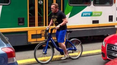 Arnold Schwarzenegger cruising the streets of Melbourne sans helmet. (Facebook)