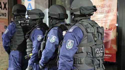 Officers from Strike Force Raptor during a raid on a bikie clubhouse in 2013.