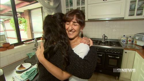 Ms Lettieri embraces her daughter today at her home, where she is recovering from minor injuries sustained in the freak accident.