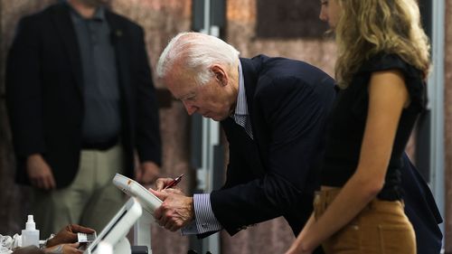 Joe Biden voting early with his granddaughter.