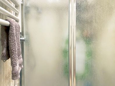 Shower with towel rail next to it