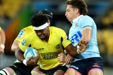 Peter Lakai of the Hurricanes is tackled during the round 11 Super Rugby Pacific match between Hurricanes and NSW Waratahs.