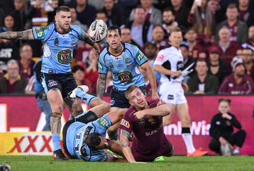 NSW players take on their Queensland counterparts in the State of Origin decider last year. (AAP)