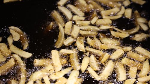 Potato chips cook in a deep fryer at a fish and chip shop on May 1, 2022 in London, England. The war in Ukraine is causing a shortage of sunflower oil. (Photo by Hollie Adams/Getty Images)