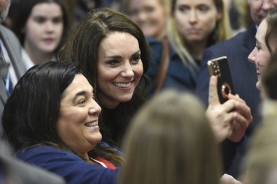 Kate, Princess of Wales, centre, poses for selfies as her and Prince William met staff and mental health first aiders during their visit of the hospital facilities at the new Royal Liverpool University Hospital, in Liverpool, England, Thursday, Jan. 12, 2023 