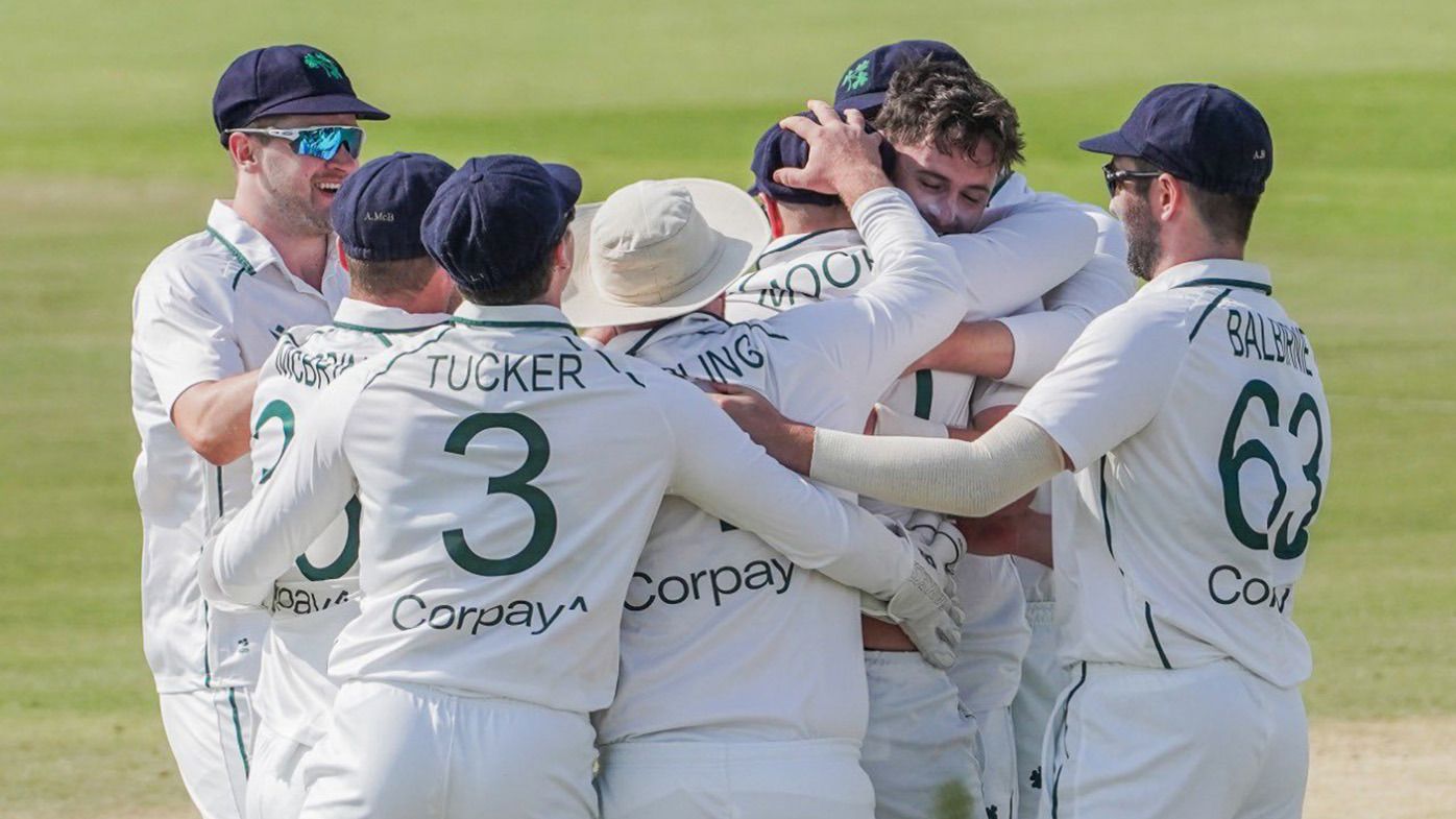 The Ireland team celebrating their maiden Test victory, defeating Afghanistan by six wickets.