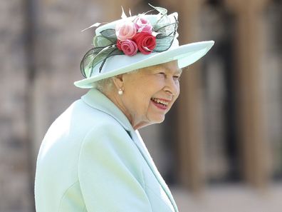 Britain's Queen Elizabeth smiles after awarding Captain Sir Thomas Moore his knighthood during a ceremony at Windsor Castle.