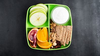 School lunch green box with oranges and crackers