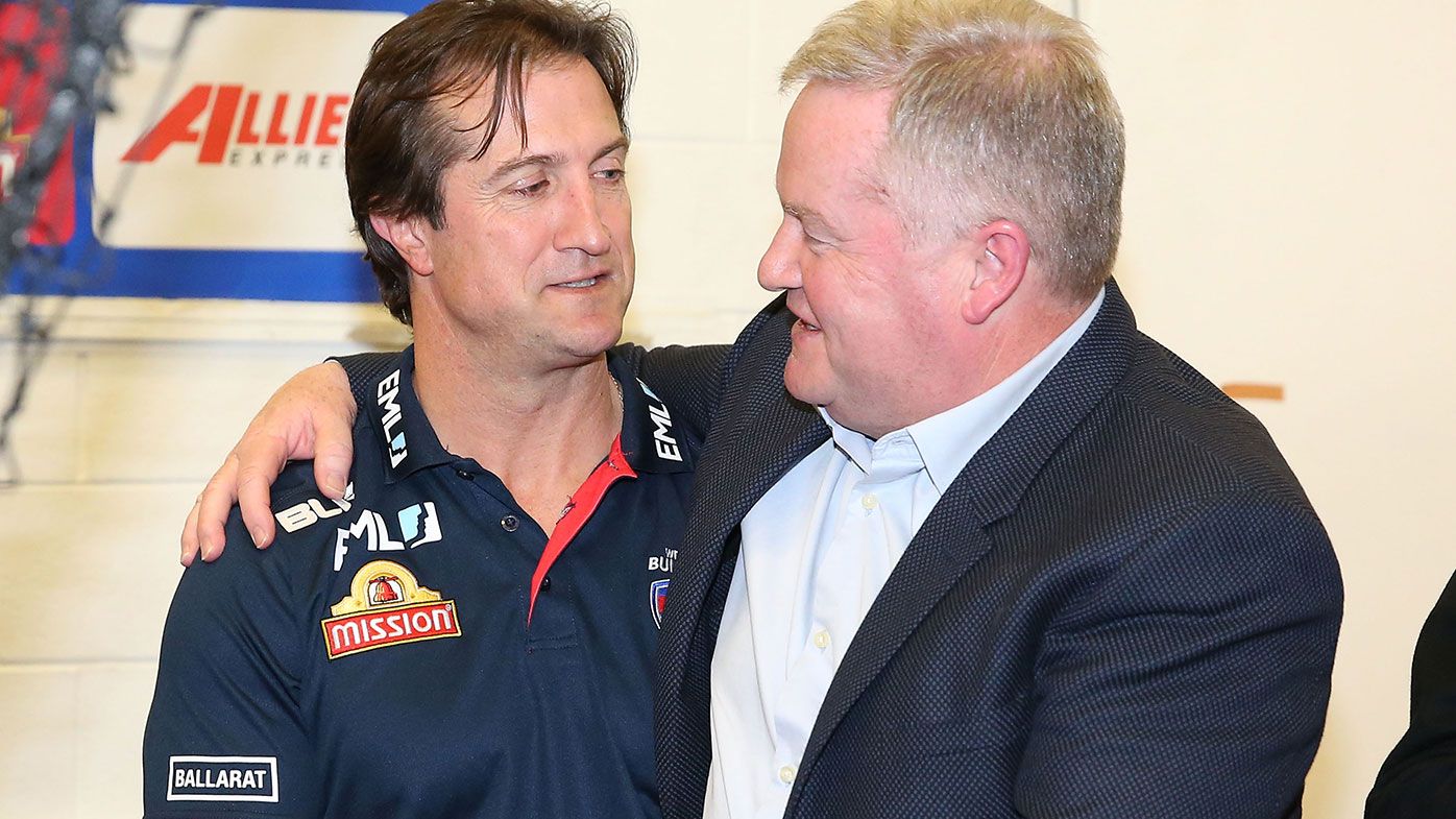 Luke Beveridge, coach of the Bulldogs is congratulated by Western Bulldogs president Peter Gordon 