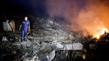 Debris from Malaysia Airlines Flight 17 is shown smouldering in a field in Grabovo, Ukraine near the Russian border. Flight 17, on its way from Amsterdam to Kuala Lumpur and carrying 295 passengers and crew. (Getty)