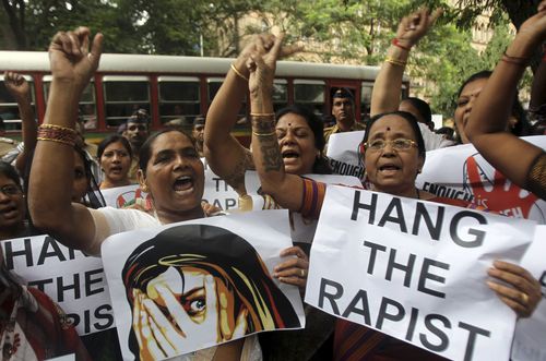 Indian activists hold placards demanding rapists be hanged as they protest against the gang rape of a 22-year-old woman photojournalist in Mumbai. (AAP)