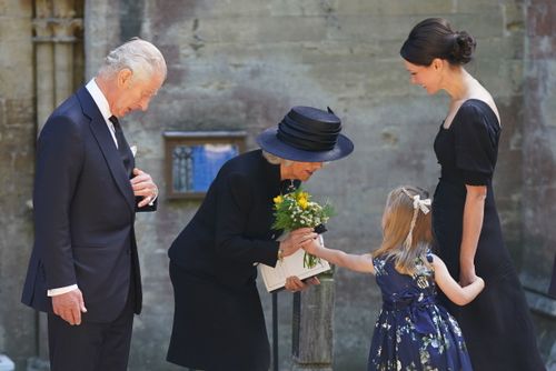 Britain's King Charles III and Camilla, the Queen Consort receive a bouquet from a girl as they leave the Llandaff Cathedral following a Service of Prayer and Reflection for the life of Queen Elizabeth II.