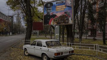 A partially torn-off Russian billboard in Kherson, southern Ukraine, Wednesday, Nov. 23, 2022. The text reads in Russian: &quot;People of Kherson is proud of Russia&quot;. (AP Photo/Bernat Armangue)
