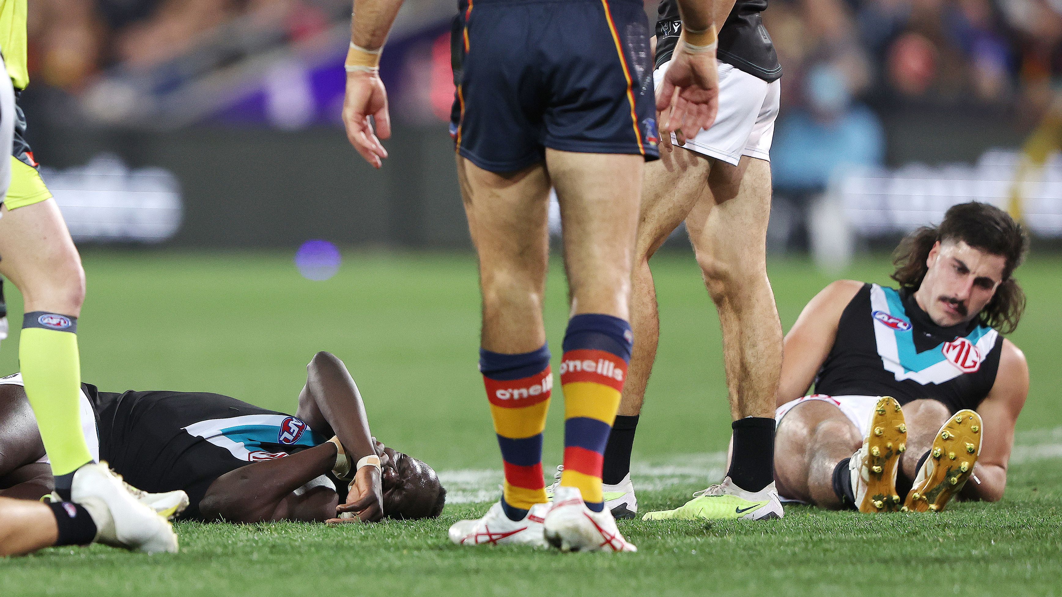 Aliir Aliir of the Power on the ground along with Lachie Jones of the Power after they collided during the 2023 AFL Round 20 match between the Adelaide Crows and the Port Adelaide Power at Adelaide Oval on July 29, 2023 in Adelaide, Australia. (Photo by Sarah Reed/AFL Photos via Getty Images)