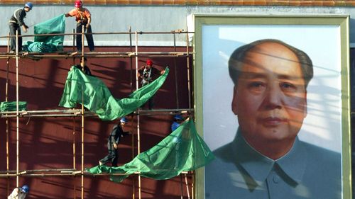 File photo of Chinese workers set up nettings for renovation work near the late Chinese leader Mao Zedong's portrait displayed on Tiananmen Gate, Beijing, China in 2004.