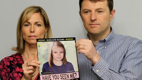 Kate and Gerry McCann hold a missing poster depicting an age progression computer generated image of their still missing daughter Madeleine, in 2012.