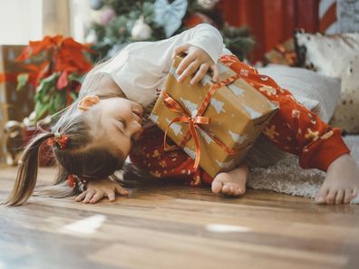 Happy cute girl receive Christmas gift.