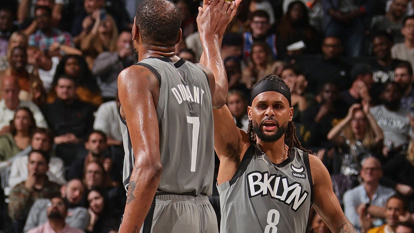 Kevin Durant #7 and Patty Mills #8 of the Brooklyn Nets high five against the Washington Wizards 