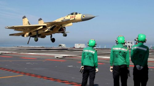 A warplane lands on the flight deck of the Liaoning. The aircraft carrier may become a test bed for an electromagnetic launch system.