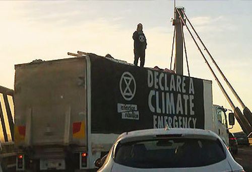 Extinction Rebellion protestors atop rented truck on West Gate Bridge (Nine)