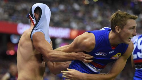 Moments after the alleged biting, McKenna tussled with Bulldogs player Bailey Dale. (AAP)