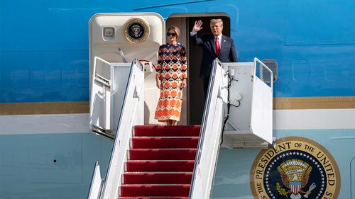 Melania and Donald Trump wave to the crowd in Palm Beach, Florida.