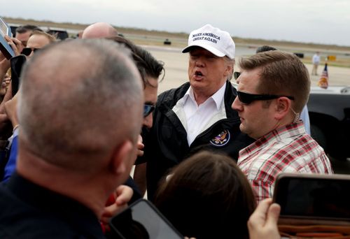 US President Donald Trump greets people after arriving at McAllen International Airport for a visit to the southern border.