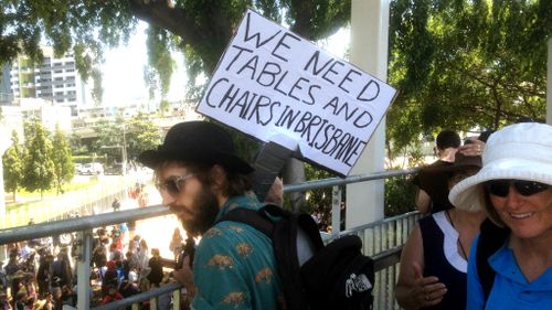 Protesting the big issues - one man had an issue with the lack of chairs in Brisbane. (9NEWS)