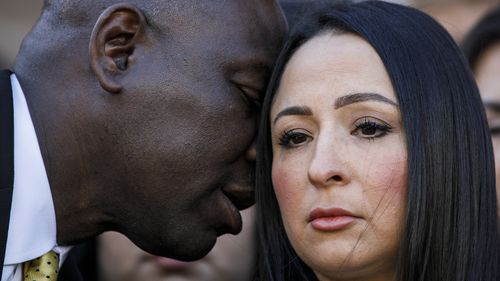 Attorney Benjamin Crump whispers to Victoria Casarez as they hold a press conference to update the public about Eric Cantu's current medical condition. (Sam Owens/The San Antonio Express-News via AP)