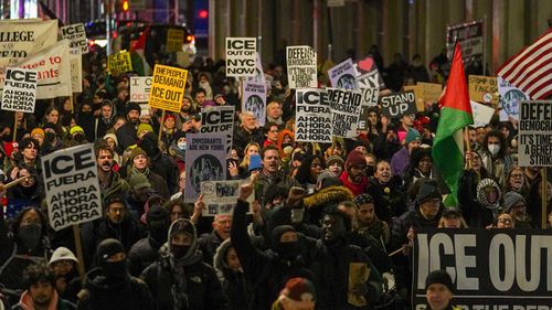 People participate in a protest in response to the fatal shooting of Renee Nicole Good in Minneapolis.