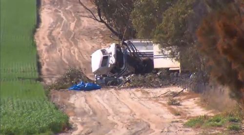 Only a hubcap and one of the car's doors are the remaining signs of a vehicle in the wreckage of the crash.