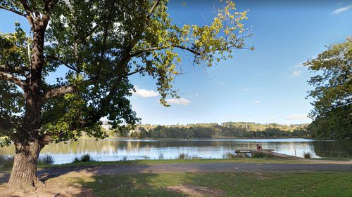 A man's body has been pulled from Lake Conobolas shortly after a swimmer vanished.