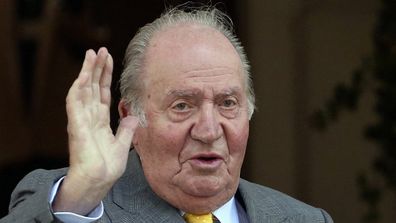 Spain's former monarch King Juan Carlos waves upon his arrival to the Academia Diplomatica de Chile in 2018.