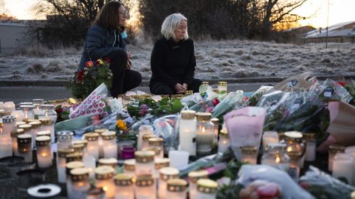 People light candles at a makeshift vigil near the scene of the shooting in Sweden on Thursday, February 6. (Jonathan Nackstrand/AFP/Getty Images via CNN Newsource.)