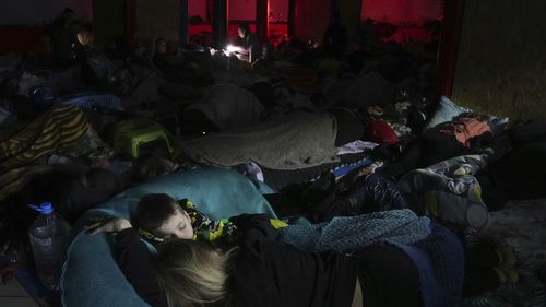 People sleep in the improvised bomb shelter in a sports centre, which can accommodate up to 2000 people, in Mariupol, Ukraine.