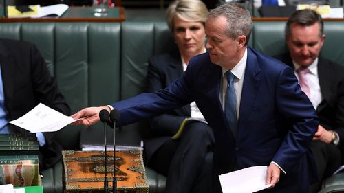 Australian Opposition Leader Bill Shorten tables the renunciation of his British citizenship at the end of House of Representatives Question Time at Parliament House.
 (AAP) 
