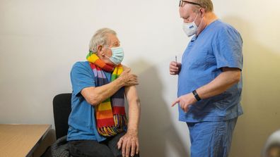 Ian McKellen talks to Dr Phil Bennett-Richards as he receives his first dose of the Covid-19 vaccine at the Arts Research Centre, Queen Mary University Hospital.