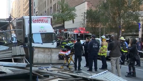 Dramatic footage shows a shed falling from a sidewalk in New York onto pedestrians, injuring 3 people