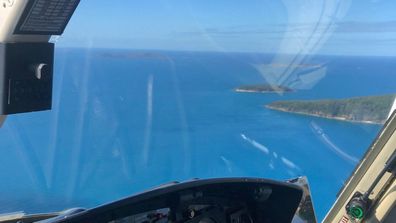 Two men are believed to have been attacked by a shark in Airlie Beach.