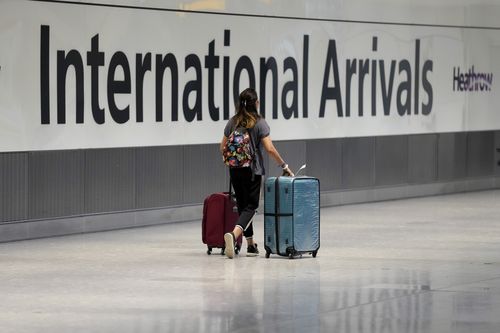 A passenger arrives from a flight at Terminal 5 of Heathrow Airport in London, Monday, August 2, 2021. 