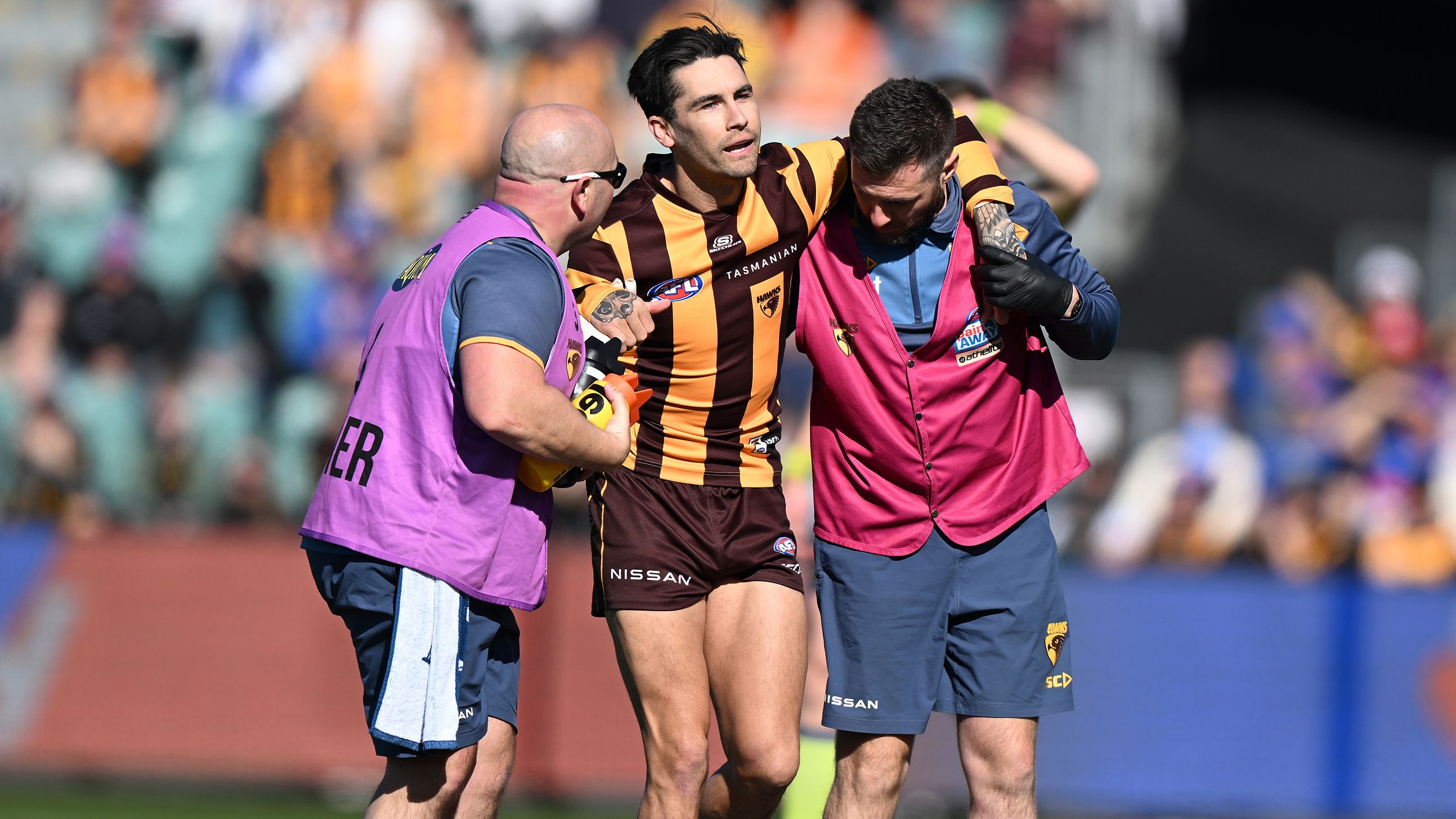 Hawthorn&#x27;s Chad Wingard is helped from the field after suffering an Achilles injury in round 22.