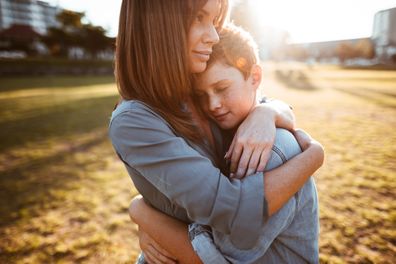 Mums hugs teenage son