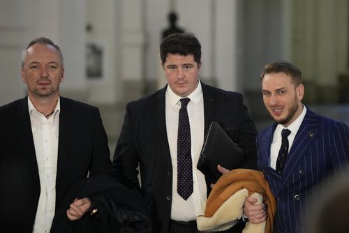 Ioan Gliga, left and Eugen Vidineac, right, Romanian lawyers and Andrew Ford a British lawyer, for Andrew Tate speak to the media at the Court of Appeal, in Bucharest, Romania, Tuesday, Jan.10, 2023.  