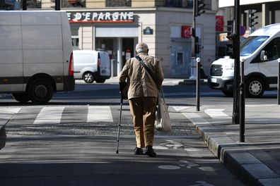 Old man crossing street
