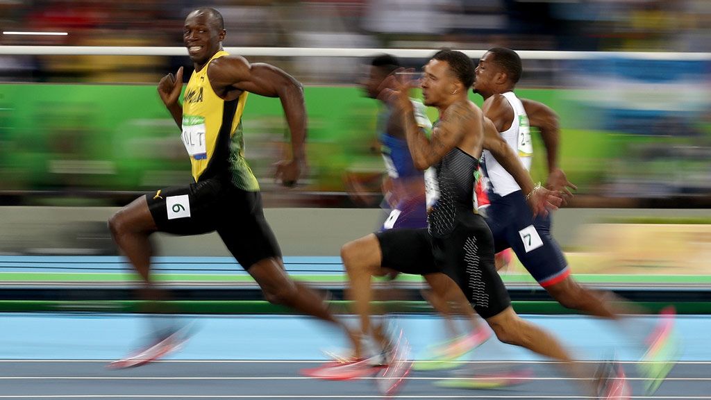 Usain Bolt smiling at the cameras during this 100m semi-final in Rio. (Getty)
