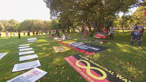 The first protesters have descended upon the Domain in Sydney