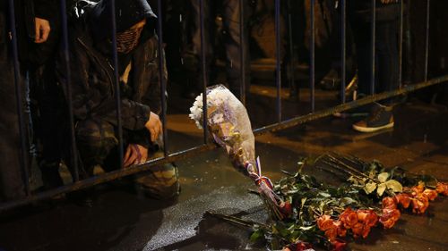 A man mourns as he put flowers at the site of murder of Boris Nemtsov. (AAP)