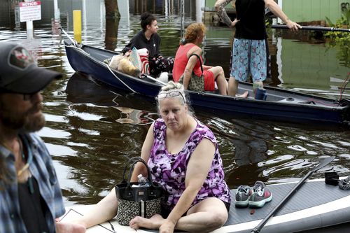 Residents of Twin City Mobile Home Park, a manufactured home community in flood zone A, navigate through the neighborhood in high waters, Wednesday, Aug. 30, 2023, in St. Petersburg, Fla. 