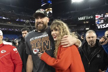 Kansas City Chiefs tight end Travis Kelce walks with Taylor Swift