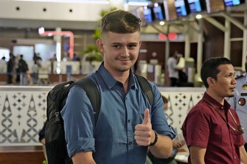 Australian national Bodhi Mani Risby-Jones from Queensland gives a thumb up as he waits for check in at Soekarno-Hatta International Airport in Tangerang, Indonesia, Saturday, June 10, 2023. 